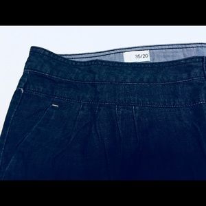 Denim mini skirt with pleats and brass buttons